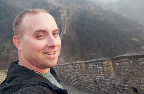 Selfie of a man standing inside the Great Wall of China