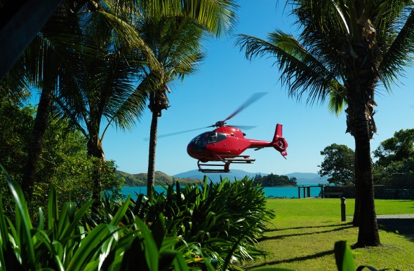  Helicopter landing on green grass at Hamilton Island 