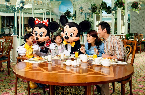  Family eating while being entertained by Minnie and Mickey mouse