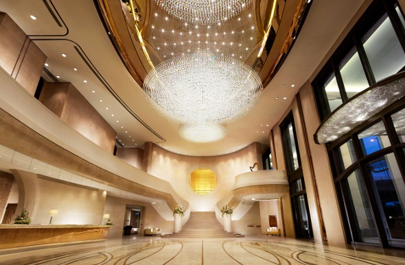 Grand hotel lobby lit up at night 