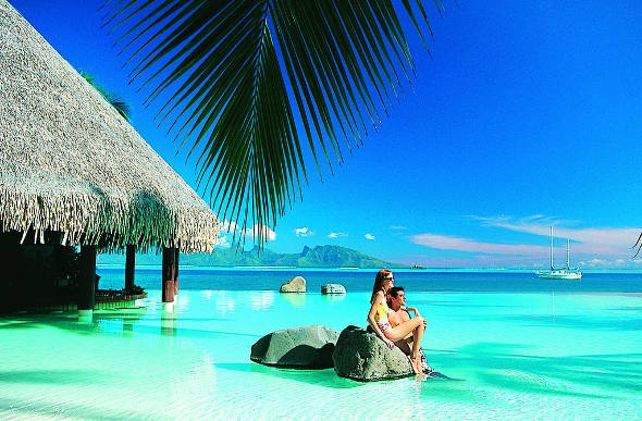 Couple relaxing on the oceanfront of InterContinental Resort Tahiti