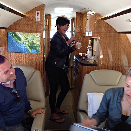  Kris Jenner pouring a drink in her private jet 