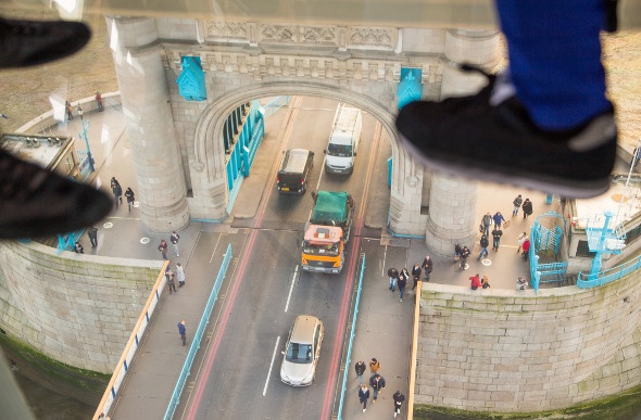 Looking down at London traffic from Tower Bridge's glass floor.