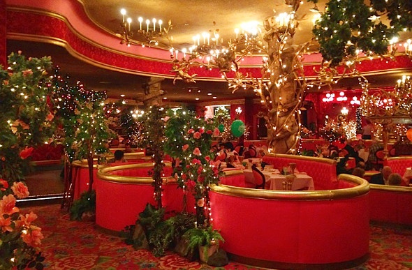  a christmas themed hote lounge with lots of christmas lights and other ornaments