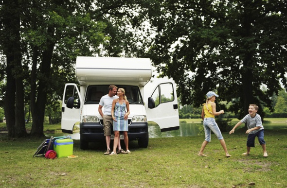 a family bonding in a park where their motorhome is parked
