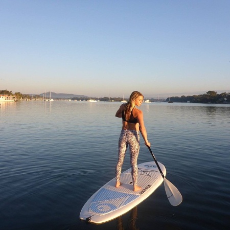  Woman standing in a board while paddling