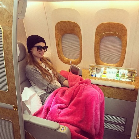  Paris Hilton relaxing with a pink blanket on a private jet 