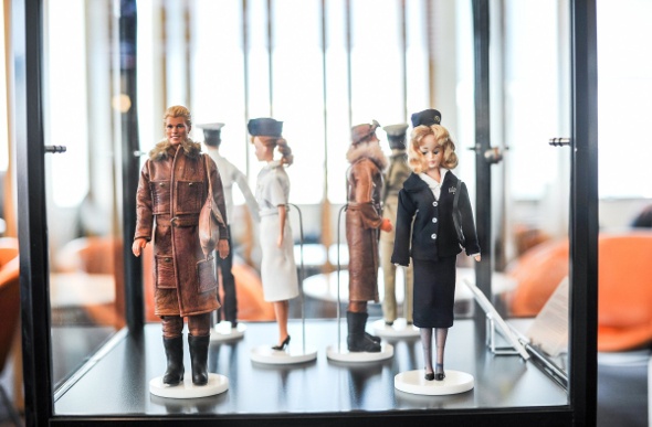 Customer barbie dolls in cabinet