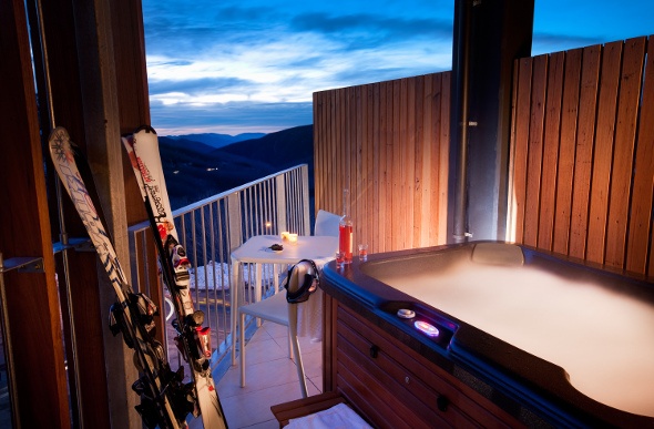 Personal hot tub with a view of the mountains at the Qt Falls Creek Hotel