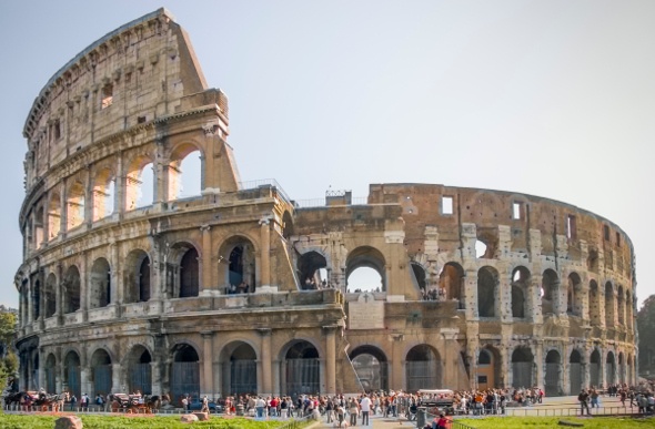  front view of the  Colloseum in Rome with tourists taking a picture