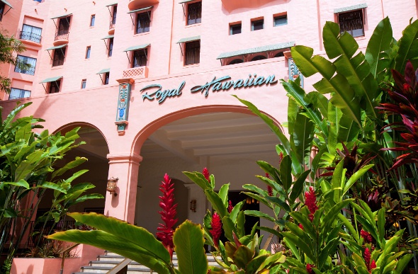 Royal Hawaiian Hotel in pink, with green and red plant decoration