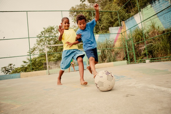  two kids playing soccer 