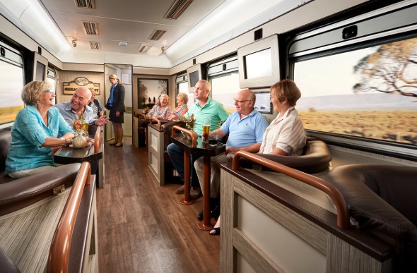  People enjoy a beer and a laugh in the Shearer's Rest lounge car on board the Spirit of the Outback train.