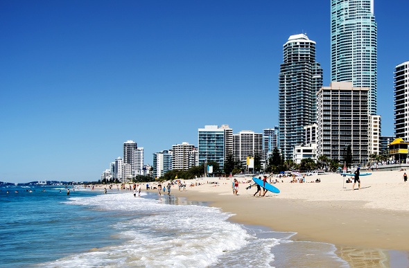  people going for a swim and surf on a beach in Gold coast