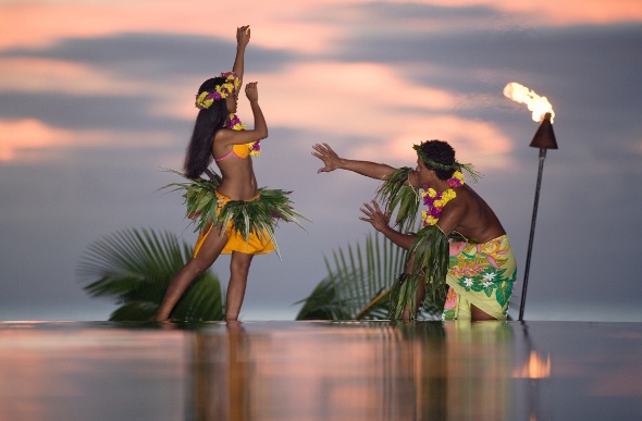 Two dancers perform in Tahiti.