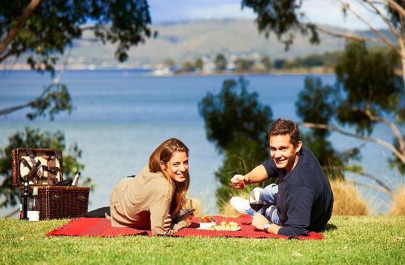  Couple having a picnic by the water 
