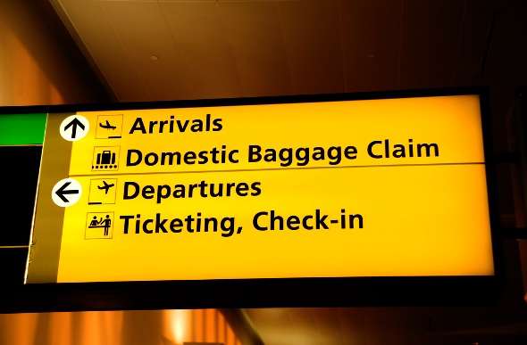  yellow wayfinding signage in an airport