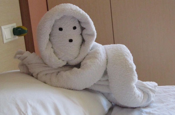  Towel origami in the shape of a person lying on the bed