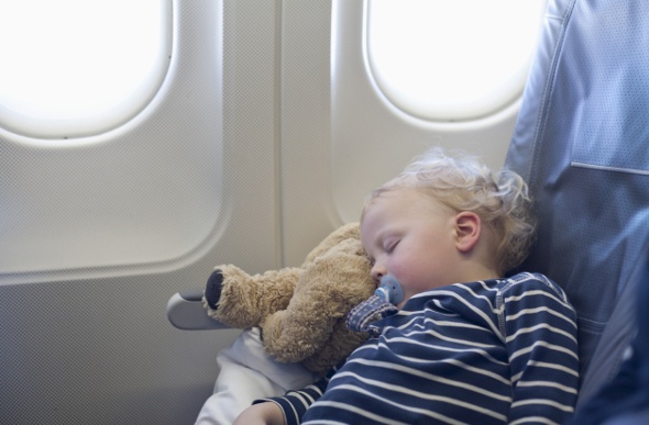  A baby boy sound asleep inside the plane