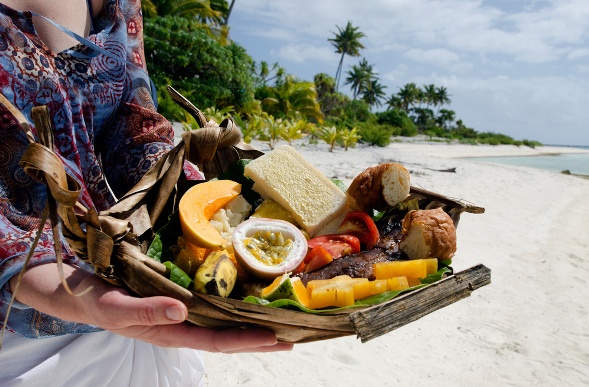 Woman holding Tropical food by the beach