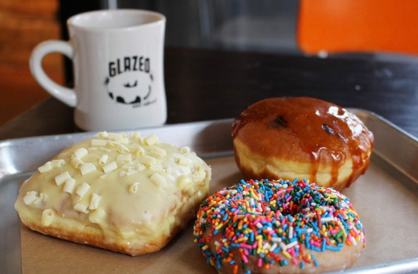 Mouth watering glazed doughnuts and a cup of coffee