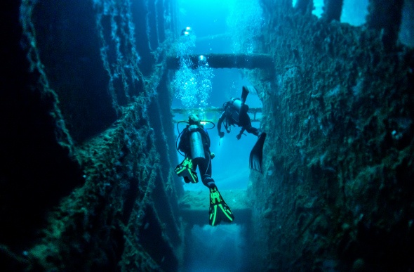 Two scuba divers exploring a ship wreck in Vanuatu