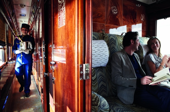 Couple having a fun conversation inside the coach of the Venice Simplon orient express