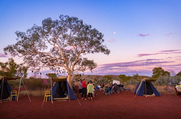 Tents line up beneath fairy lights in Karijini National Park, Western Australia.
