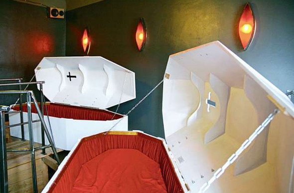  Two open red and white coffins in hotel room 