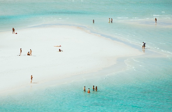 People play in the shallow waters of Hill Inlet in the Whitsundays. Picture: Jason Charles Hill
