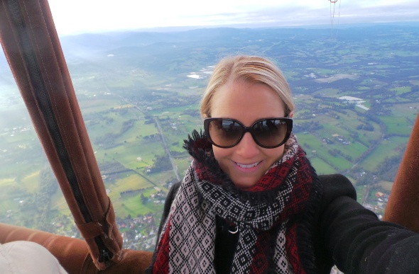  Woman in an air balloon wearing sunglasses and a red and black scarf 