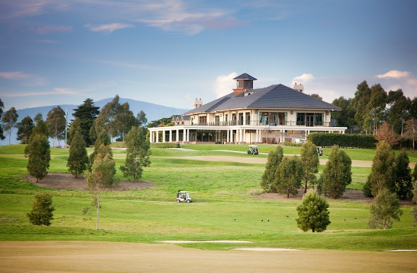  A photo of the Yarra Valley Lodge surrounded by green grass and trees 