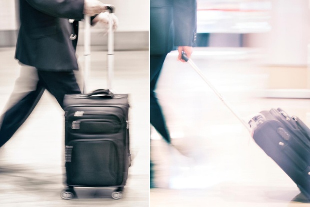 A person pulling his suitcase base on its wheels