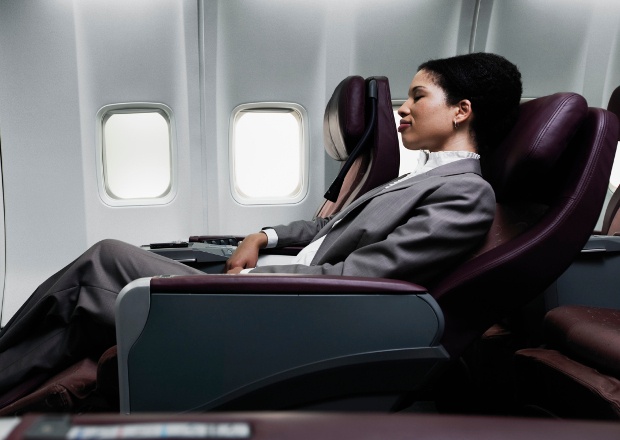 Business class passenger unwinds with her seat reclined