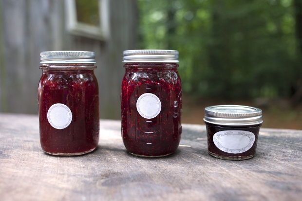 Three different containers filled with red jam