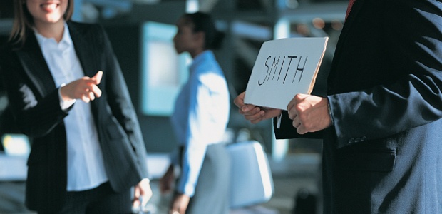 Driver holding a surname sign at the airport 