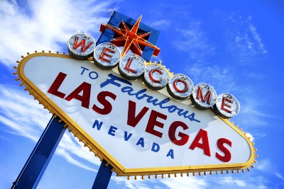 'Welcome to Las Vegas' sign in front of the cloudy blue sky