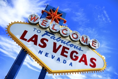 'Welcome to Las Vegas' sign in front of the cloudy blue sky 