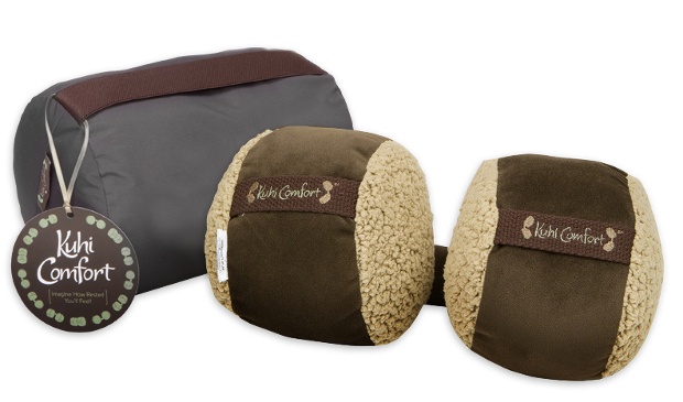 Two round, brown travel pillows with a case
