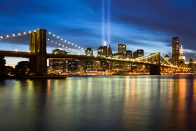 The New York Skyline and Brooklyn Bridge lit up at night