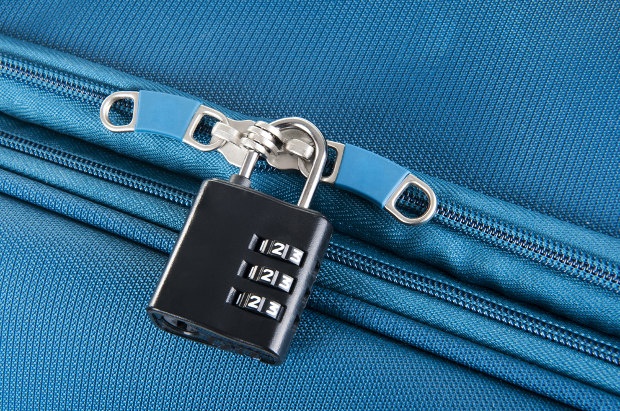 Close-up shot of a 3-digit combination lock on a suitcase