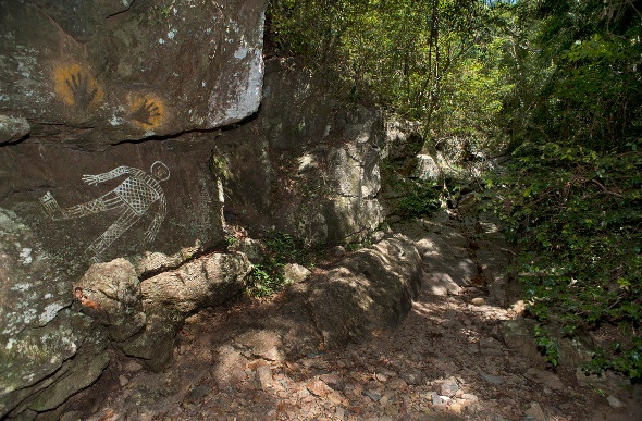 rock formations with drawings and hand prints