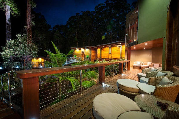 a relaxing outdoor view with beautiful plant foliage and outdoor couches in a spa