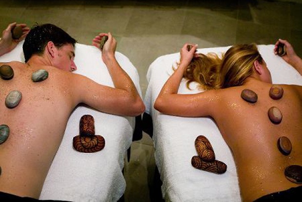 a couple getting a hot stone massage together