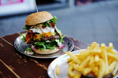 Hamburger and fries on a wooden table