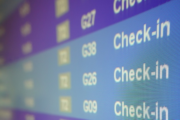 An LED screen showing scheduled flights for Virgin Australia