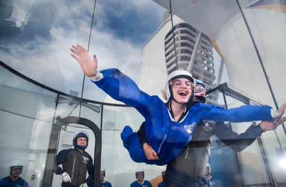 A woman skydives in a wind tunnel on board cruise ship Ovation of the Seas.