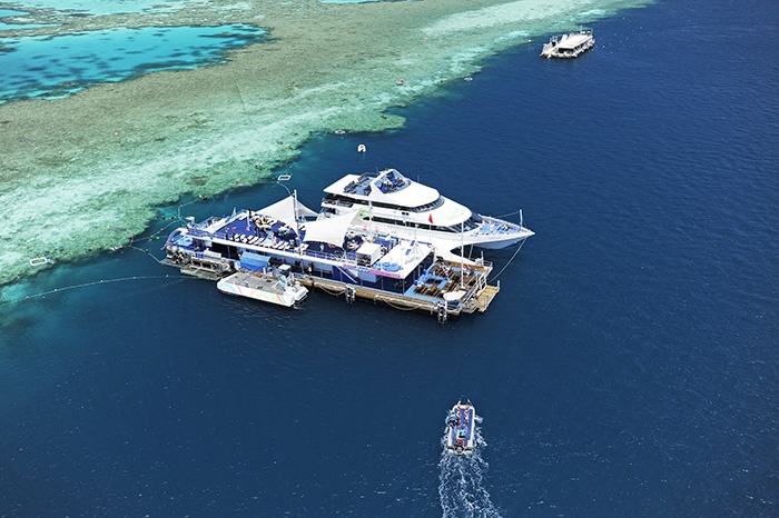 Two  yachts parked near shallow corals