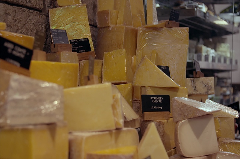 Different cheeses on display at a cheesemonger.
