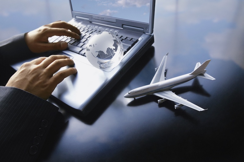 Aircraft figurine next to a man using a laptop connected to the web